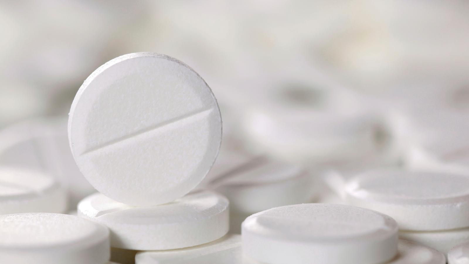 Белые пилюльки на черноте стоковое изображение. изображение насчитывающей снадоб